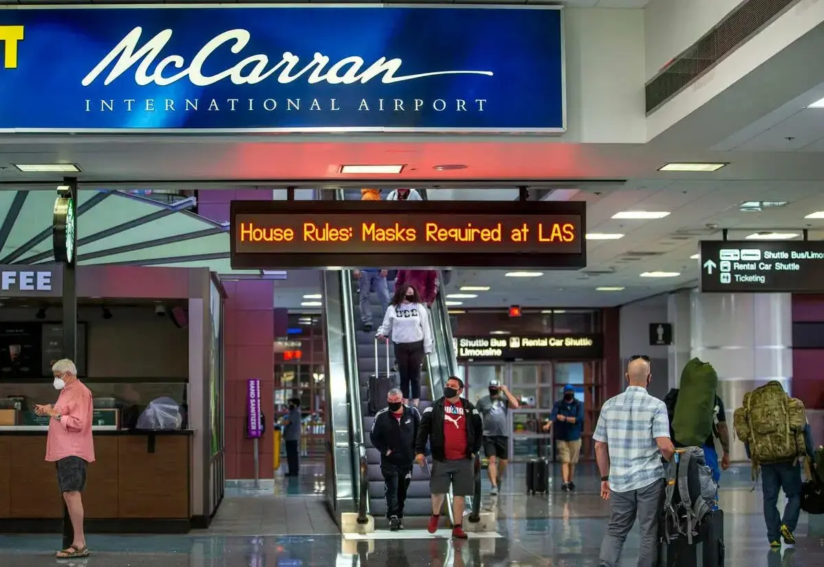 Travelers inside the Las Vegas airport terminal.